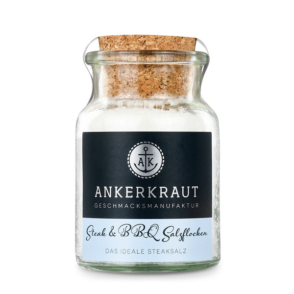 Salzflocken von Ankerkraut im Korkenglas auf weißem Hintergrund.
